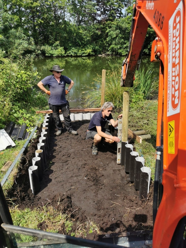 Area shows a sunken pathway being built into the ground